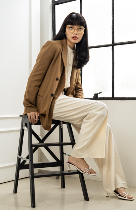 Woman sitting on a ladder